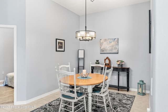 dining space featuring light tile patterned flooring and an inviting chandelier