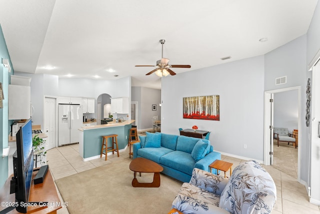 tiled living room with ceiling fan