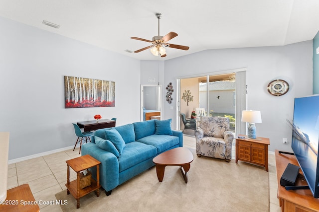 living room with lofted ceiling, ceiling fan, and light tile patterned floors