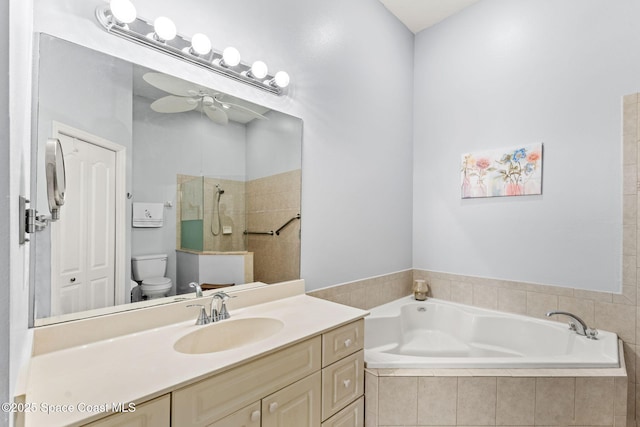 bathroom with toilet, tiled tub, and vanity