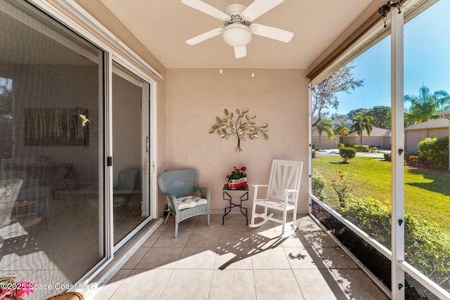 sunroom featuring ceiling fan