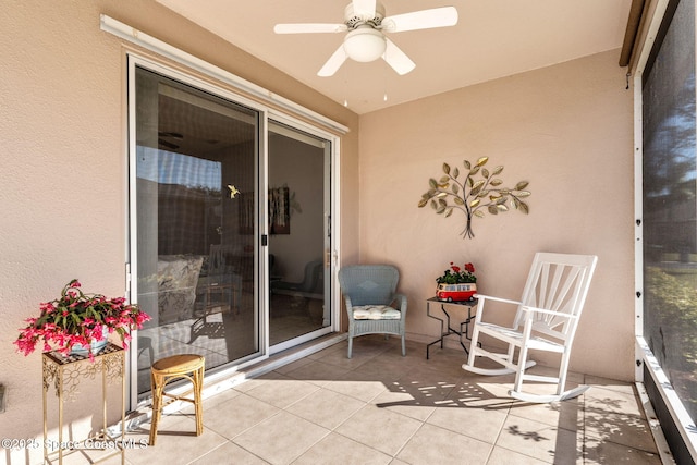 view of patio featuring ceiling fan and a balcony