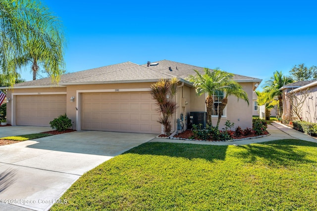 view of front of house with a front yard, a garage, and central air condition unit