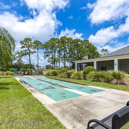 view of swimming pool with a lawn