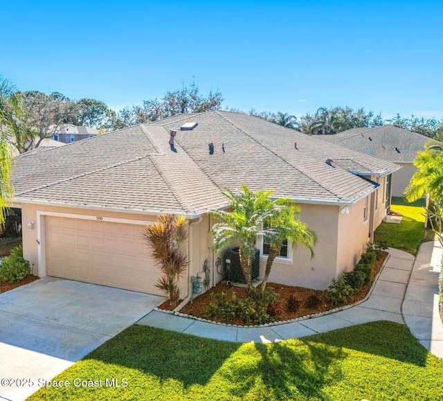 ranch-style house with central air condition unit and a garage