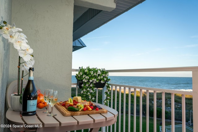 balcony featuring a water view and a view of the beach