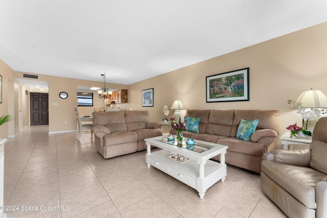 living room with light tile patterned flooring and a chandelier