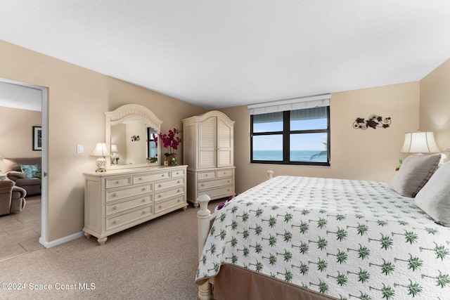 bedroom featuring light carpet