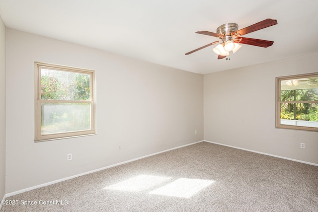 spare room featuring ceiling fan and carpet