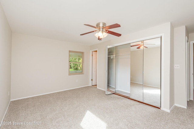 unfurnished bedroom with ceiling fan, carpet floors, and a closet