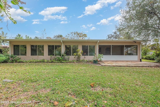 rear view of property featuring a lawn