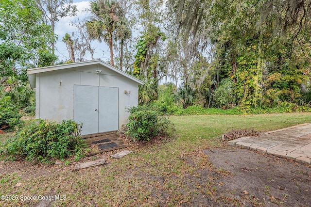 view of outbuilding featuring a lawn