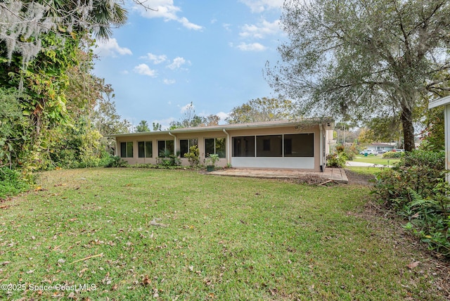 rear view of house with a lawn