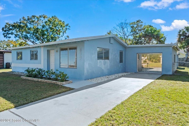 ranch-style home with a front yard and a carport