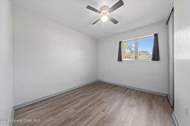 empty room featuring ceiling fan and light wood-type flooring