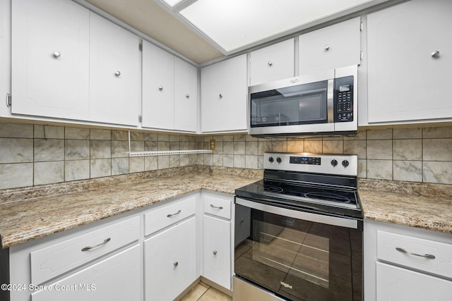 kitchen with tasteful backsplash, white cabinetry, and stainless steel appliances