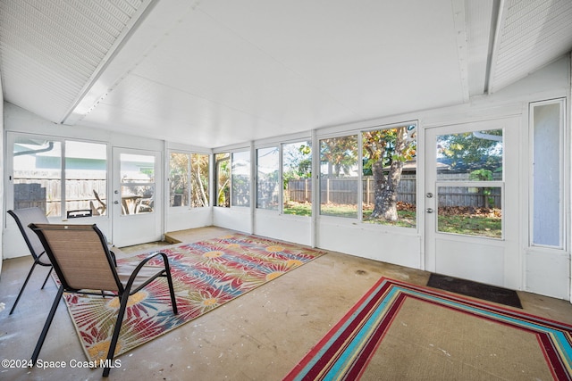 unfurnished sunroom with lofted ceiling