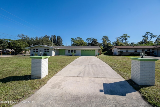 ranch-style home with a front yard and a garage