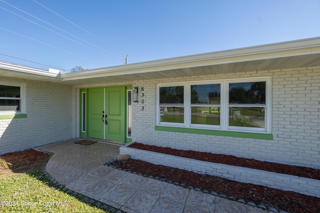 8303 Sylvan Dr, Melbourne, FL 32904 - doorway to property featuring brick siding