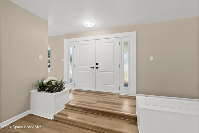 8303 Sylvan Dr, Melbourne, FL 32904 - entrance foyer featuring wood finished floors and baseboards