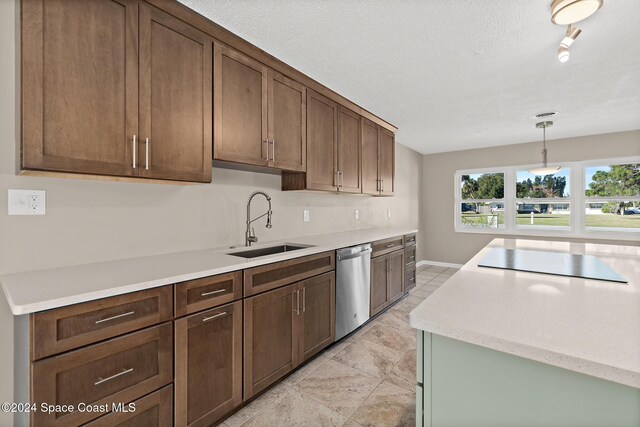 8303 Sylvan Dr, Melbourne, FL 32904 - kitchen with stainless steel dishwasher, black electric stovetop, a sink, pendant lighting, and a textured ceiling