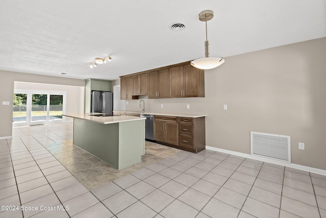8303 Sylvan Dr, Melbourne, FL 32904 - kitchen featuring appliances with stainless steel finishes, a sink, light countertops, pendant lighting, and baseboards