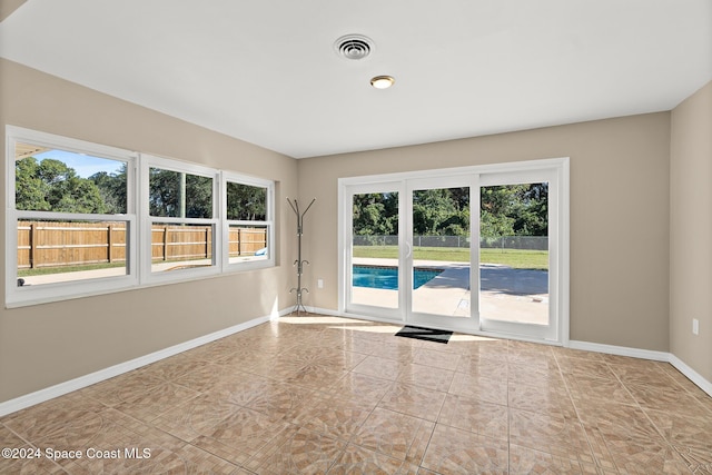 8303 Sylvan Dr, Melbourne, FL 32904 - empty room featuring baseboards and tile patterned floors
