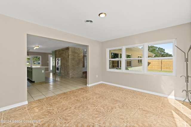 tiled empty room with a wealth of natural light