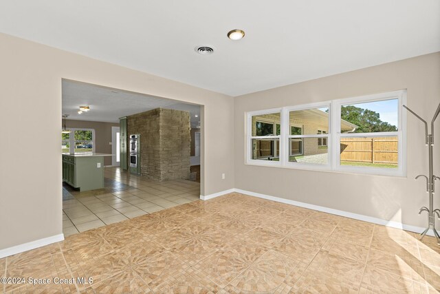 8303 Sylvan Dr, Melbourne, FL 32904 - spare room with light tile patterned floors and baseboards