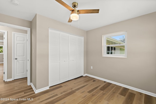 8303 Sylvan Dr, Melbourne, FL 32904 - unfurnished bedroom featuring baseboards, light wood-style floors, and a closet