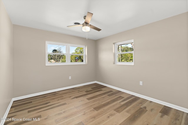 spare room with ceiling fan and wood-type flooring