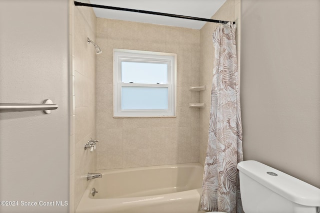 bathroom with shower / bath combo and toilet