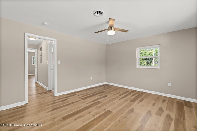 empty room featuring ceiling fan and light hardwood / wood-style flooring