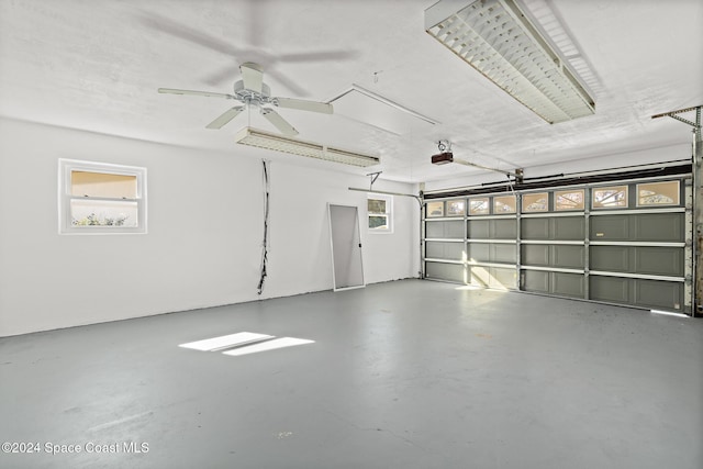 garage featuring a garage door opener and ceiling fan