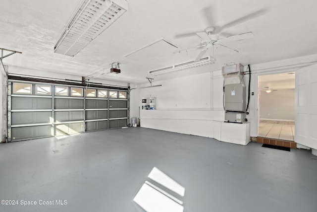 8303 Sylvan Dr, Melbourne, FL 32904 - garage with a garage door opener, heating unit, and a ceiling fan
