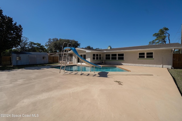 8303 Sylvan Dr, Melbourne, FL 32904 - view of swimming pool featuring a water slide and a patio