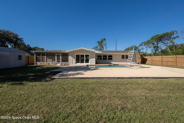 8303 Sylvan Dr, Melbourne, FL 32904 - rear view of property featuring a patio, a sunroom, and brick siding