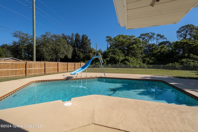 8303 Sylvan Dr, Melbourne, FL 32904 - view of swimming pool with a water slide and a patio