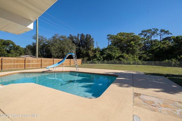8303 Sylvan Dr, Melbourne, FL 32904 - view of pool with a patio, a water slide, and view of wooded area