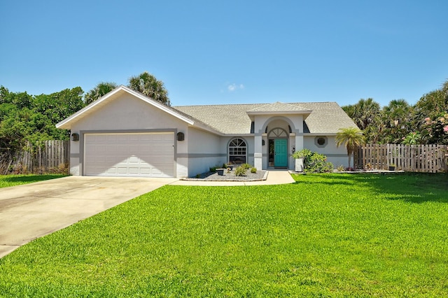 ranch-style house featuring a front yard and a garage