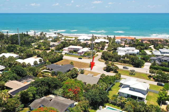 drone / aerial view with a water view and a beach view