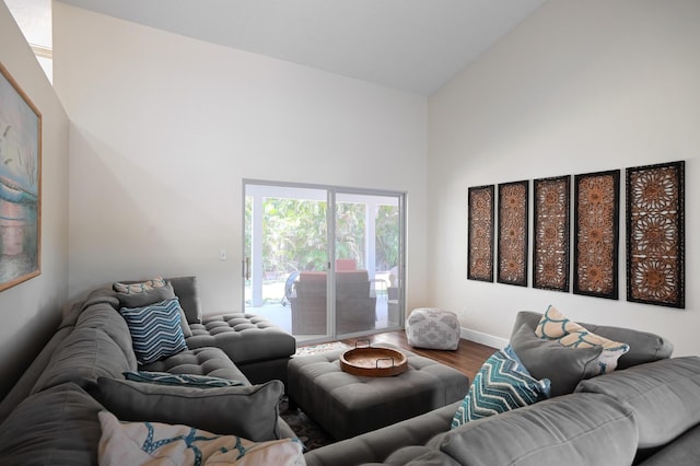 living room with high vaulted ceiling and hardwood / wood-style flooring