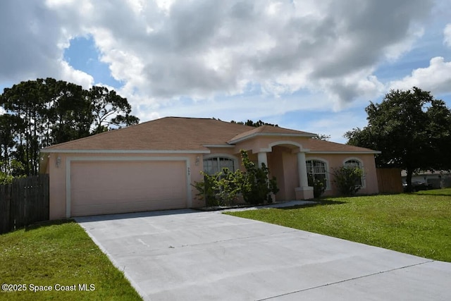 single story home with a garage and a front yard