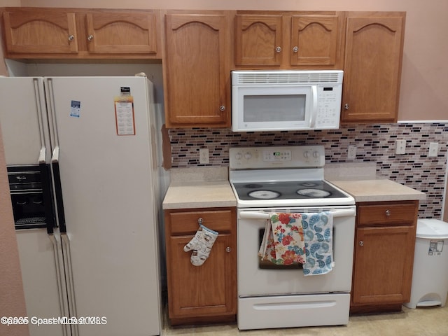 kitchen with decorative backsplash and white appliances