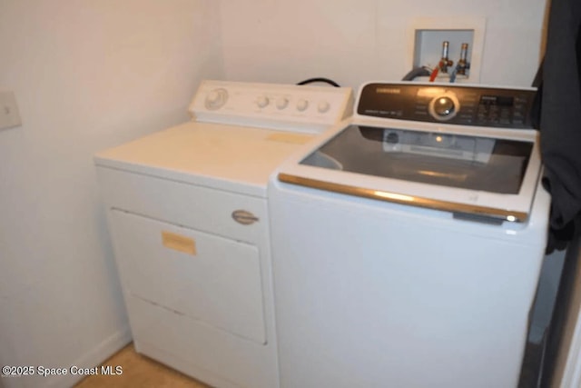 laundry area with washing machine and clothes dryer