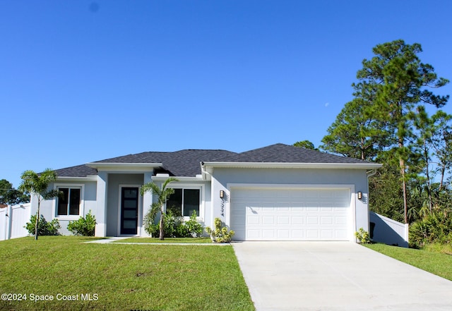 view of front facade with a front yard and a garage