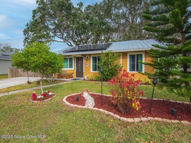 ranch-style house with a front yard and solar panels