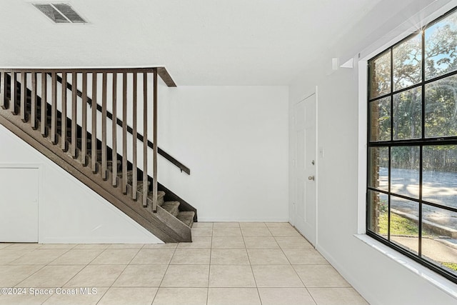 tiled foyer entrance featuring a healthy amount of sunlight