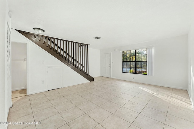 unfurnished living room with light tile patterned floors