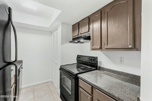 kitchen with black appliances and light tile patterned flooring